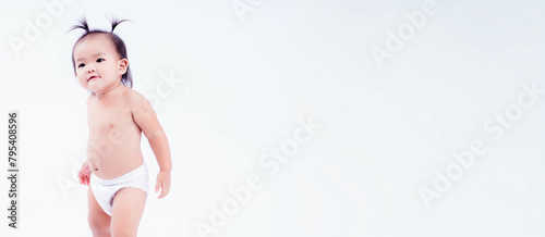 A cute toddler with a curious expression walking alone on a white background, embodying discovery. Studio shot, copy space
