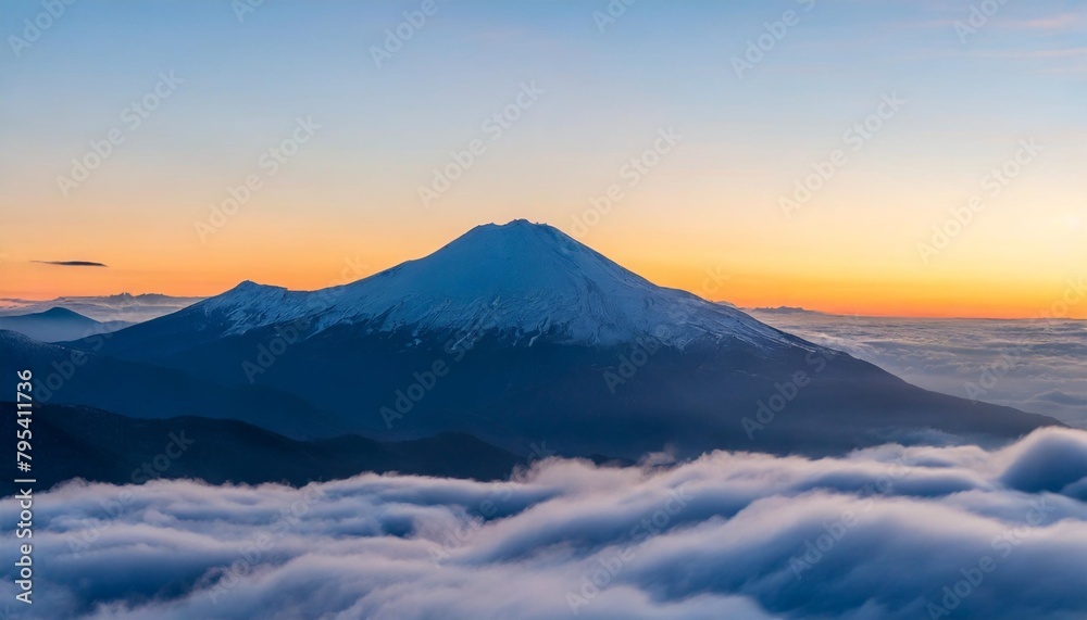 a mountain covered in snow is surrounded by clouds at sunset