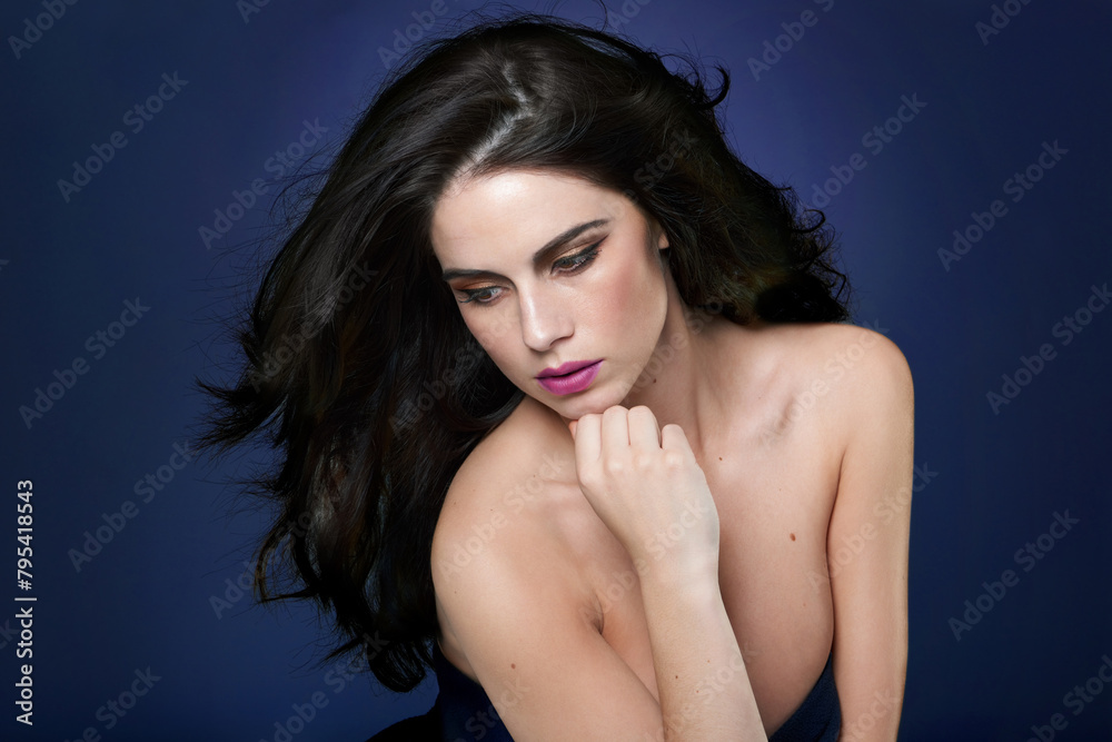 Fototapeta premium Thinking, wellness or woman in studio for hair cosmetics, shine and luxury glamour on blue background. Makeup, beauty or model with shampoo, scalp or glow haircare results, growth and smooth texture