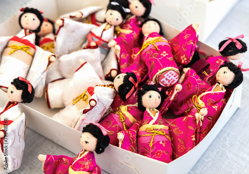 Small Japanese dolls in kimono in a box.