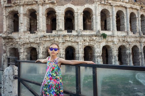 Girl in front of the ancient facade of open-air Theatre of Marcellus (Teatro di Marcello) in sunny day, Rome, Italy photo