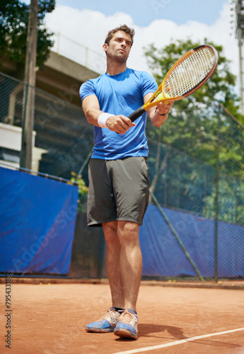 Man, confident and serve in outdoor tennis match, game and court for competition or practice. Male person, athlete and ready for training or exercise, workout and hobby for action and play fitness © peopleimages.com