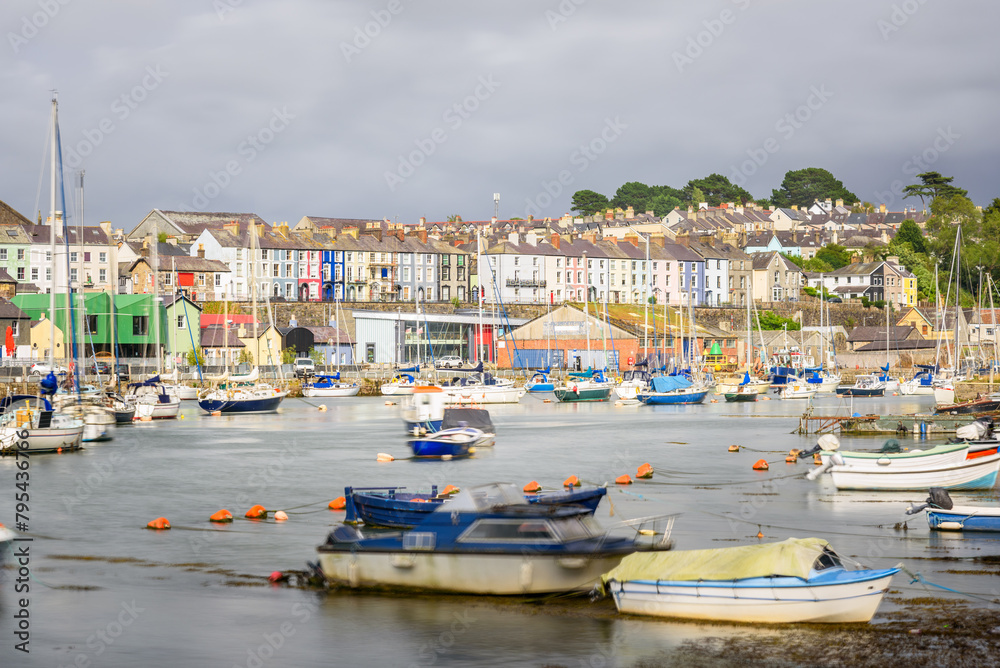 Colourful terraced houses overlooking a harbour under storm sky in summer