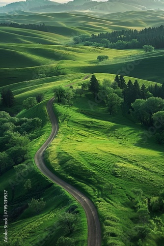 b'Green rolling hills with a winding road through the valley'