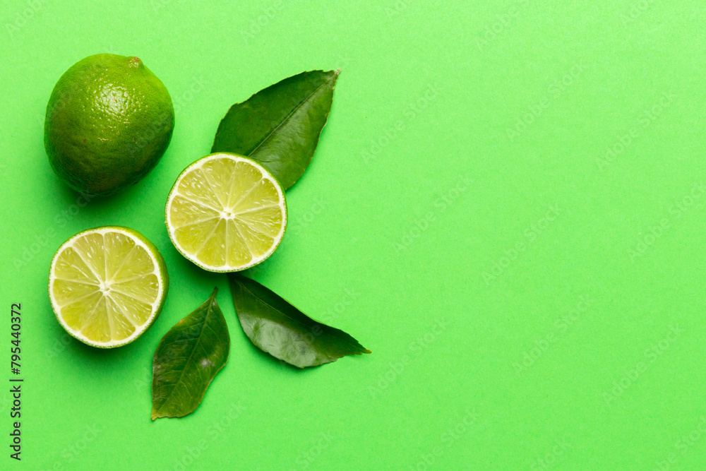 Lime fruits with green leaf and cut in half slice isolated on white background. Top view. Flat lay with copy space Lime fruits with green leaf and cut in half slice isolated on white background. Top view. Flat lay with copy space