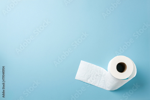 Top view of toilet paper roll on blue background © yalcinsonat