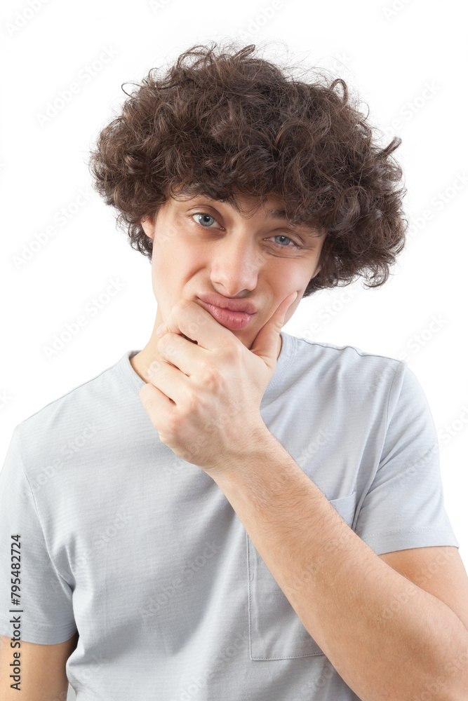Funny and handsome, a young man with curly hair, he looks into the camera with his blue eyes, his hands on his face, a portrait of a guy wearing a T-shirt isolated against a white background Funny and handsome, a young man with curly hair, he looks into the camera with his blue eyes, his hands on his face, a portrait of a guy wearing a T-shirt isolated against a white background