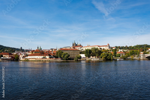 Scenic view of Moldova River with skyline of City of Prague with St. Vitus Cathedral and castle the background on a sunny autumn day. Photo taken October 11th, 2023, Prague, Czech Republic.