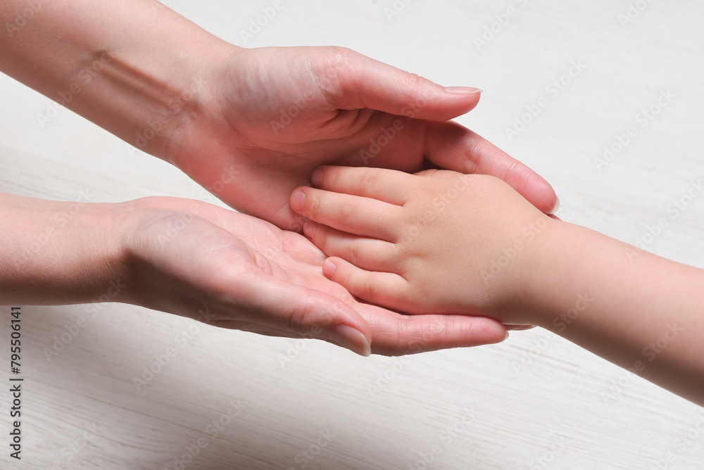 World mother day concept background. Mother and son hands close up. World mother day concept background. Mother and son hands close up.