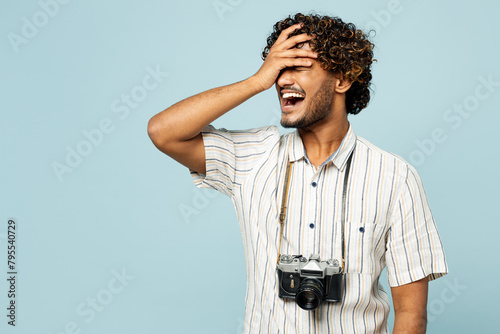 Traveler man wear white casual clothes put hand on face facepalm epic fail omg gesture isolated on plain blue background. Tourist travel abroad in free spare time rest getaway Air flight trip concept #795540729