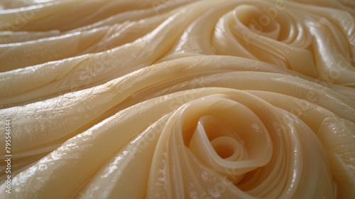   A tight shot of an untouched pasta pile  adorned with ample olive oil atop