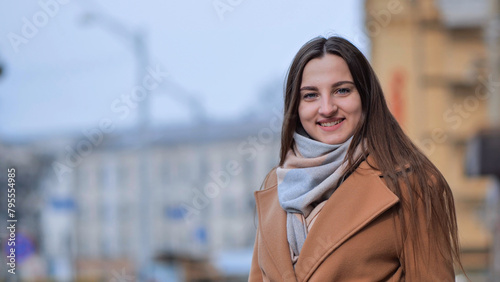 Beautiful young girl portrait in a coat in spring