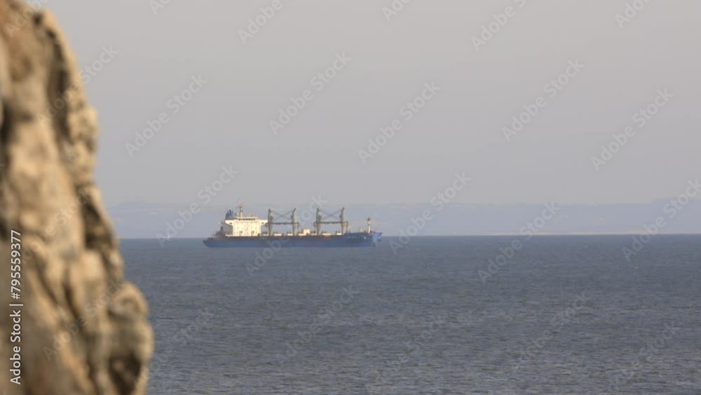 A large blue ship is sailing in the ocean A large blue ship is sailing in the ocean