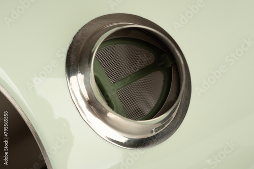 Close-up of the filter screen in the spout of the kettle.
