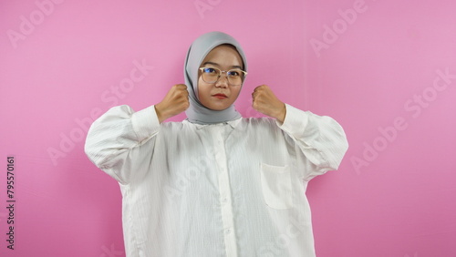 Indonesian Muslim woman posing on a pink background