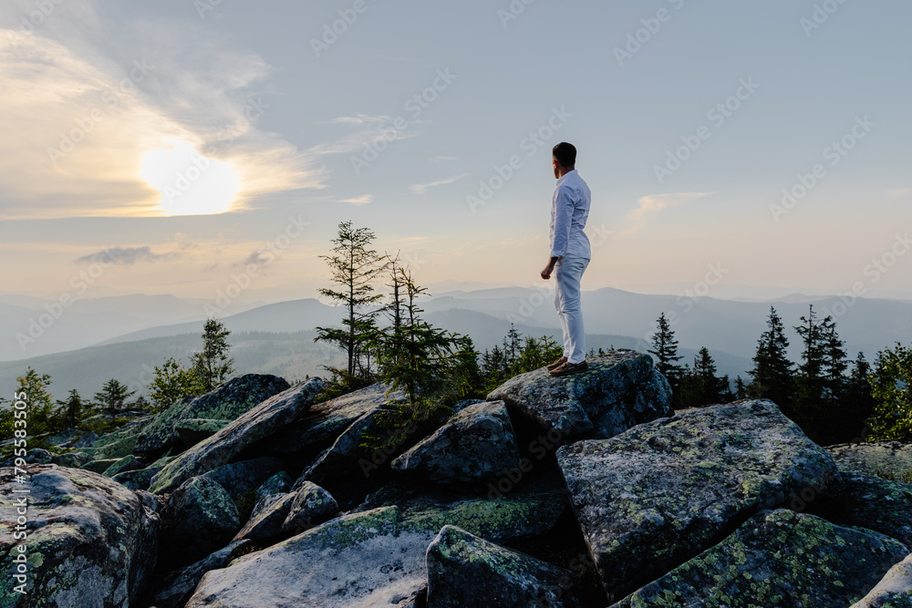 Man standing on rocky mountain summit