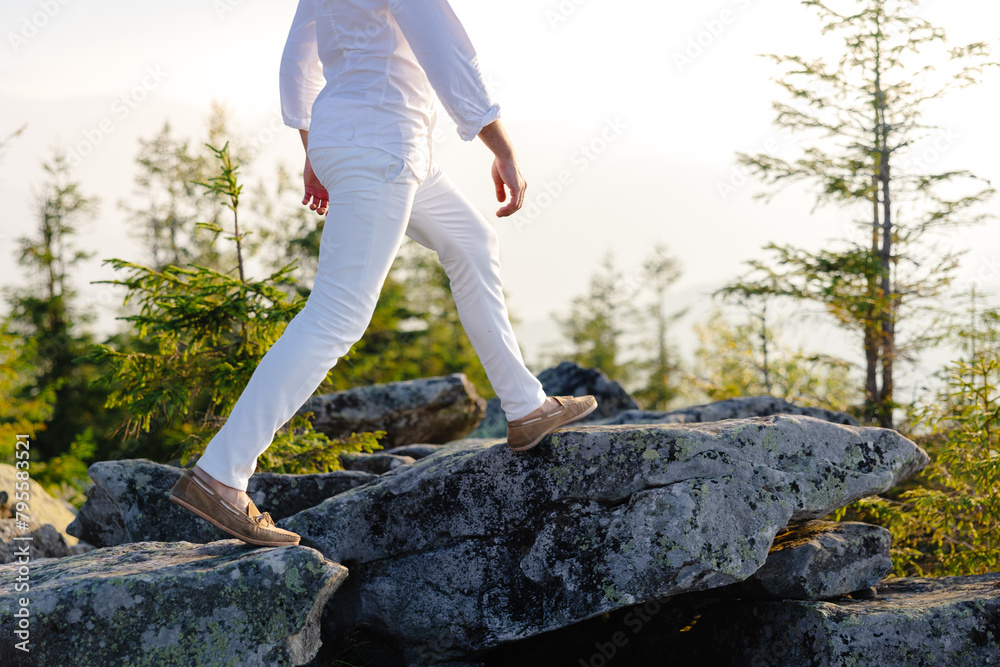Naklejka premium Man walking on rock in woods