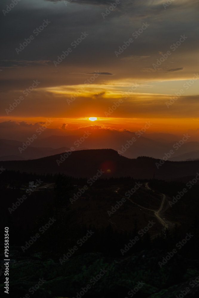 Sun setting over mountain range Sun setting over mountain range