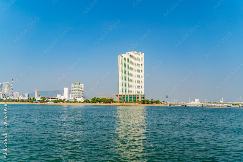 The city is from a distance from the sea.
Nha Trang city in Vietnam. View of the city from the sea. The city is from a distance from the sea.
Nha Trang city in Vietnam. View of the city from the sea.