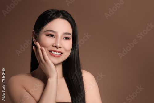 Portrait of beautiful woman on brown background, space for text