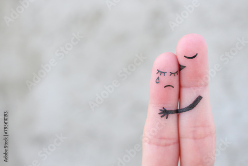 Finger art of displeased couple. Woman cries, man reassures her. He kisses and hugs her.