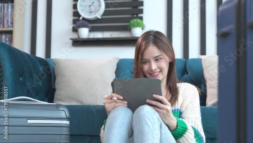 Asian happy young woman planning vacation travel and payment for flight ticket booking hotel online using laptop at home. getting ready for journey , Vacation traveling concept.