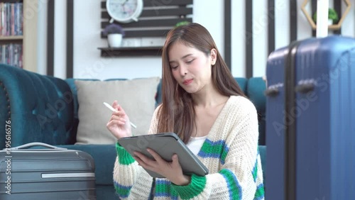 Asian happy young woman planning vacation travel and payment for flight ticket booking hotel online using laptop at home. getting ready for journey , Vacation traveling concept.