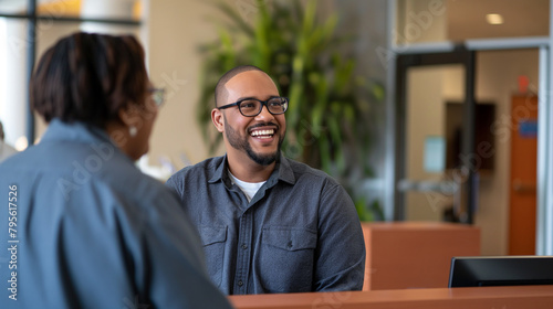 In a welcoming reception area, a man smiles as he discusses enlistment options with an enthusiastic recruiter, the scene reflective of the transformative journey ahead.