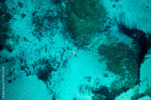 Aerial view of a lone kayak in the Sardinian crystal waters photo