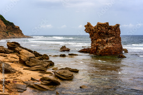 Ancient ruins on Porto Paglia beach with cloudy skies photo