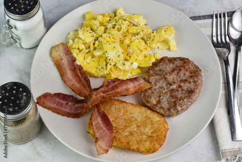 scramble egg with sausage patty and hash browns
