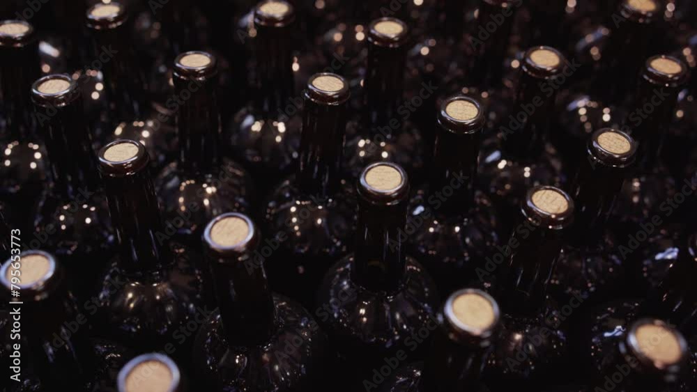 Close up video of dark glass bottles of wine with cork stoppers