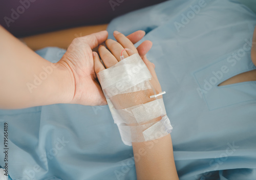 Cropped shot of patient hand receiving intravenous fluid directly in hospital. Conceptual of Intravenous therapy,are lying and being treated in beds in hospitals.
