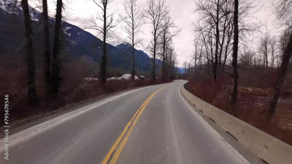 Scenic Road surrounded by Mountains and Trees on Cloudy Day. Spring Season. Highway in Pemberton, British Columbia, Canada. Scenic Road surrounded by Mountains and Trees on Cloudy Day. Spring Season. Highway in Pemberton, British Columbia, Canada.