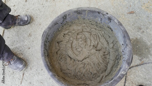 Cement in a plastic bucket. Large bucket with solution, top view.