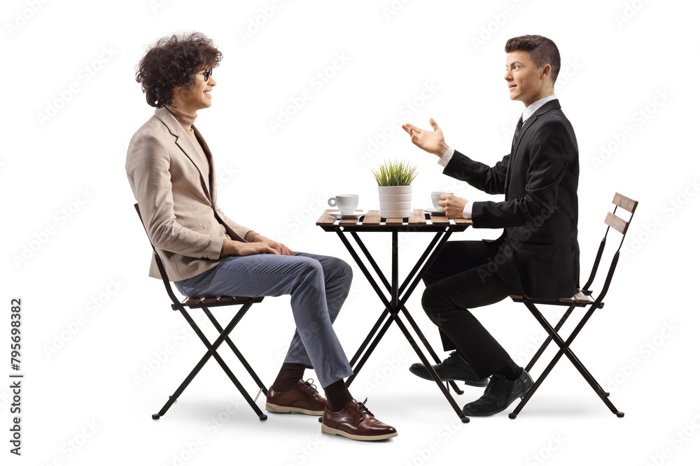 Fototapeta premium Young male coworkers in a cafe sitting and talking