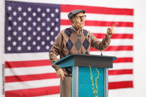 USA flag and mature male speaker talking on a pedestal photo