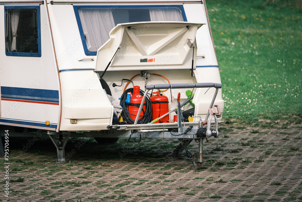 there are 2 gas cylinders in the storage space of a caravan