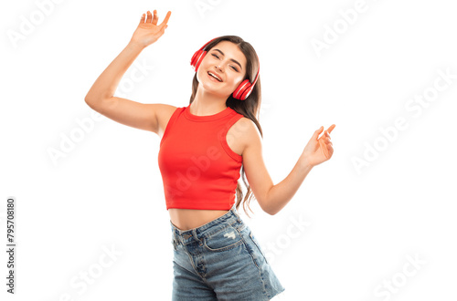 A beautiful young girl in a red T-shirt listens to music on red headphones.