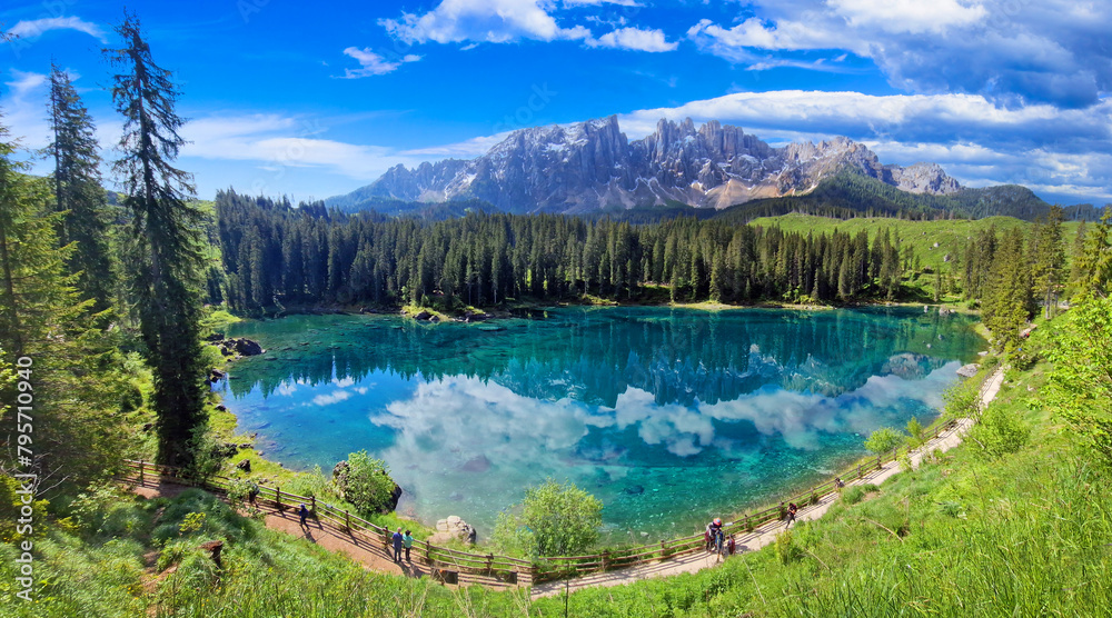 Italy Idyllic nature scenery- trasparent mountain lake Carezza surrounded by Dolomites rocks- one of the most beautiful lakes of Alps. South Tyrol region.