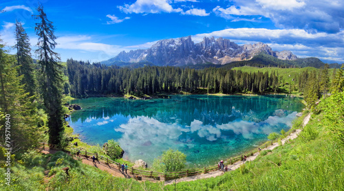 Italy Idyllic nature scenery- trasparent mountain lake Carezza surrounded by Dolomites rocks- one of the most beautiful lakes of Alps. South Tyrol region. photo