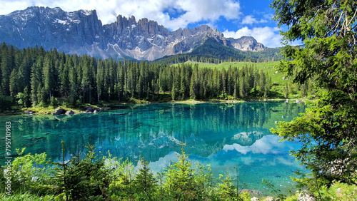 Italy Idyllic nature scenery- trasparent mountain lake Carezza surrounded by Dolomites rocks- one of the most beautiful lakes of Alps. South Tyrol region.