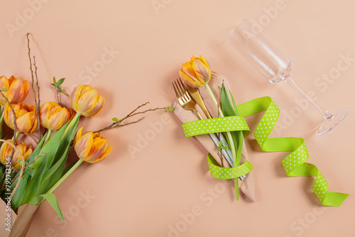 Celebrate spring with a stylish table setting featuring orange tulips  ideal for Easter or a birthday dinner.