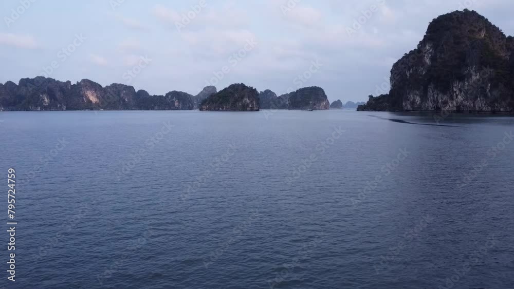 Skimming over the shimmering surface of Halong Bay, this footage captures the intimate dance of water and light near the limestone mountains. Skimming over the shimmering surface of Halong Bay, this footage captures the intimate dance of water and light near the limestone mountains.