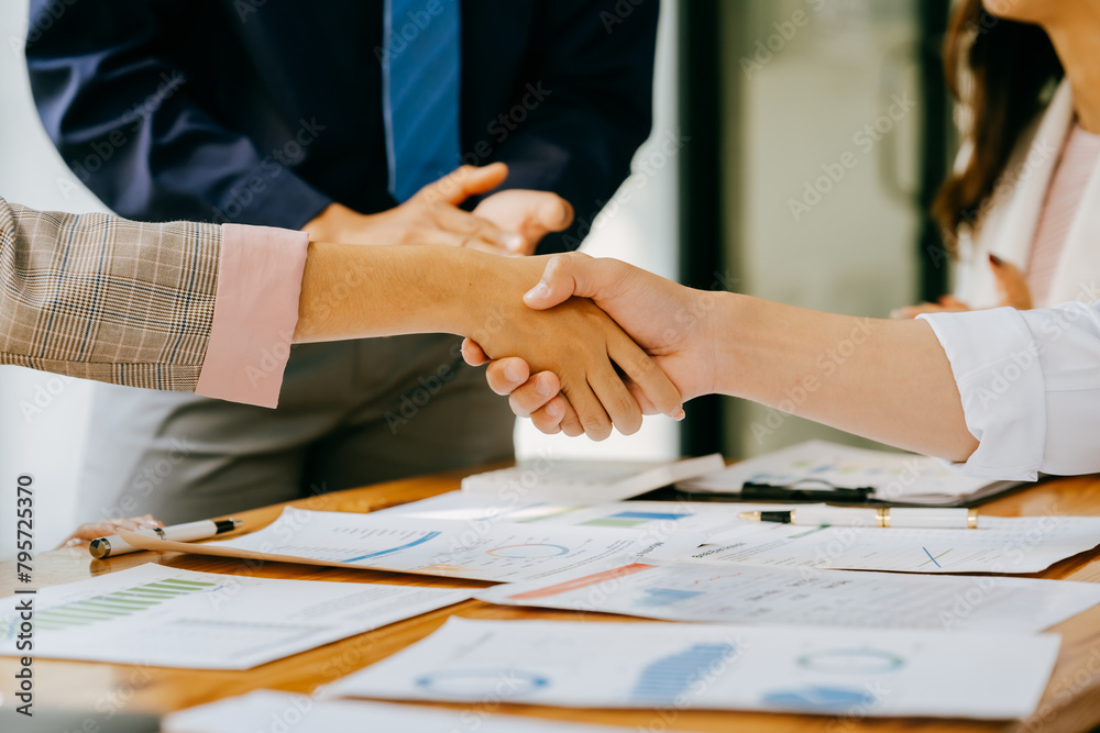 Business people shake hands with business partners at a meeting. The concept of organizational dispute settlement.