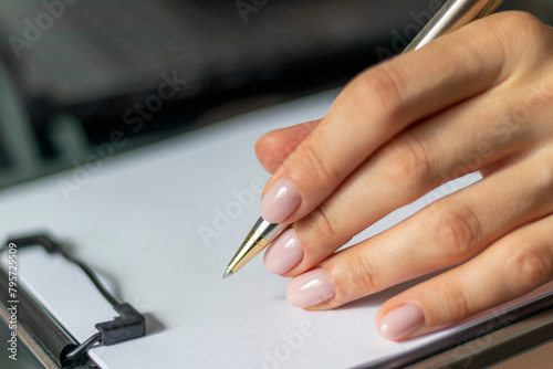Close up shot of the woman with beautiful hands in the business attire, working in the office, making notes, Business
