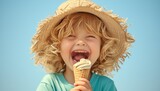 Cute little boy eating ice cream on blue background, summer concept. Happy kid in hat holding cone with white soft gelato or vanilla icre completely smiling and laughing, copy space for text