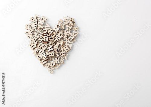wooden letters of the English alphabet in the form of a heart on a white background