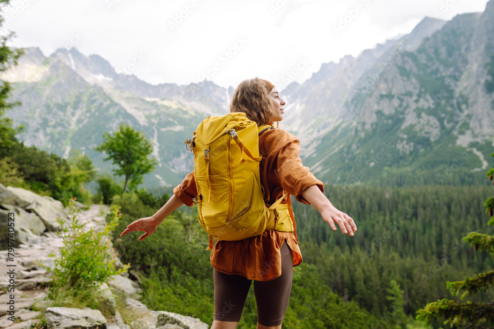 Portrait of a successful tourist on the mountain and enjoying freedom. Concept of trekking, active lifestyle. Adventures Portrait of a successful tourist on the mountain and enjoying freedom. Concept of trekking, active lifestyle. Adventures