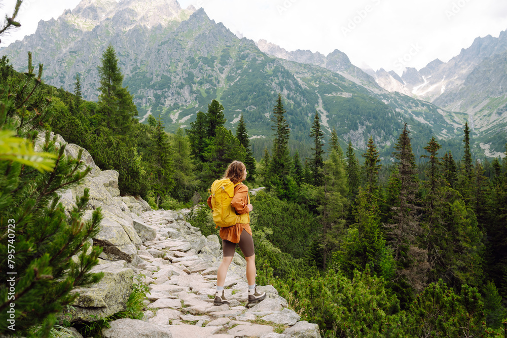 Portrait of a successful tourist on the mountain and enjoying freedom. Concept of trekking, active lifestyle. Adventures Portrait of a successful tourist on the mountain and enjoying freedom. Concept of trekking, active lifestyle. Adventures
